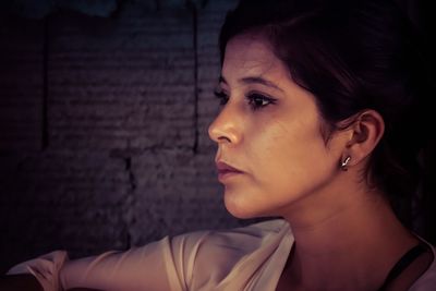 Close-up of beautiful young woman looking away