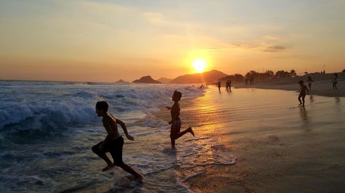 People on beach at sunset