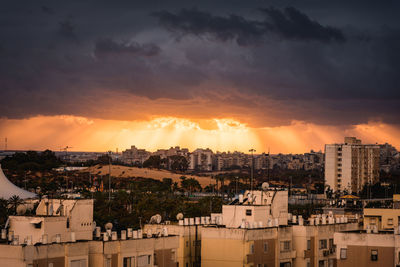 Cityscape against sky during sunset