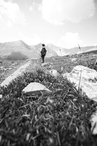 Man standing on field against sky