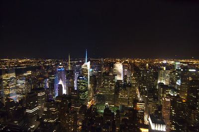 Illuminated bank of america tower and cityscape against sky at night