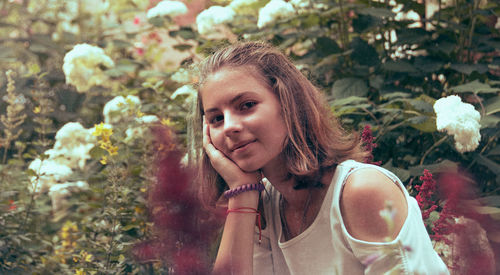 Portrait of smiling teenage girl against plants