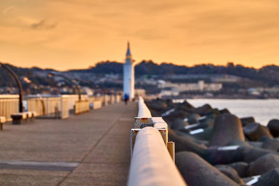 Low section view of tower in city at sunrise