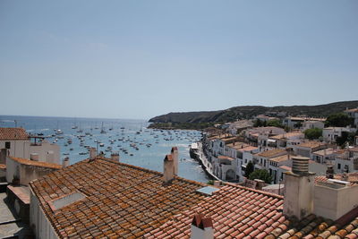 High angle view of townscape by sea against sky