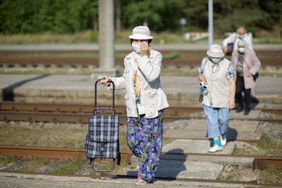 Portrait of women standing on railroad track