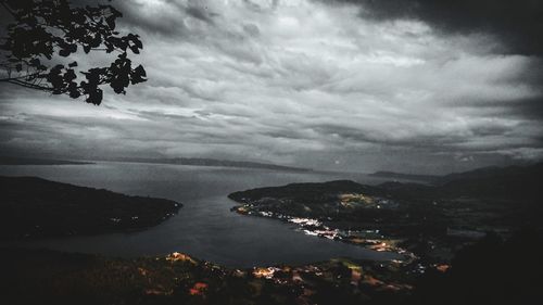 Aerial view of sea and mountains against sky