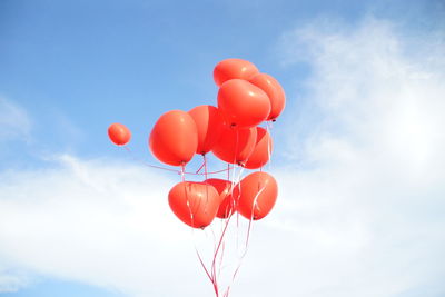 Low angle view of balloons against sky