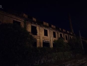 Low angle view of old building against sky at night