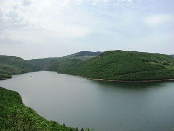 Scenic view of lake and mountains against sky