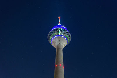 Low angle view of illuminated tower against sky at night