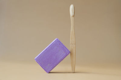 High angle view of wooden clothespin against gray background