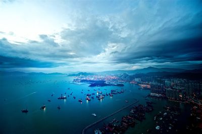 High angle view of crowd in city by sea against sky