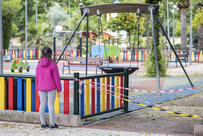 Rear view of woman standing in park