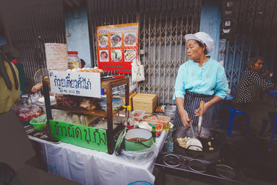 Full length of man standing at market stall