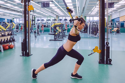 Woman exercising with resistance band at gym