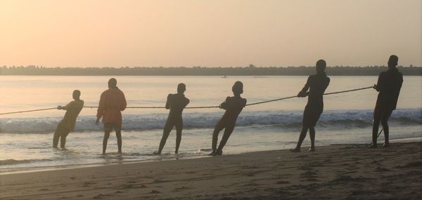 People on beach at sunset