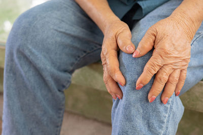Midsection of man holding hands