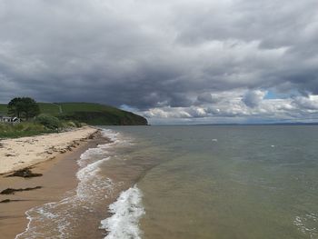 Scenic view of sea against storm clouds