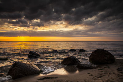 View of sea against cloudy sky during sunset