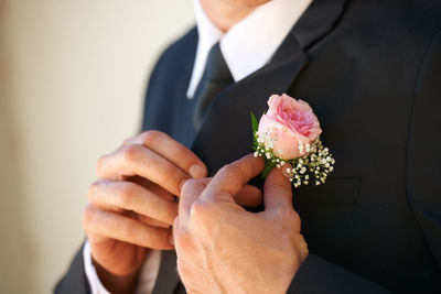 Midsection of businessman holding bouquet