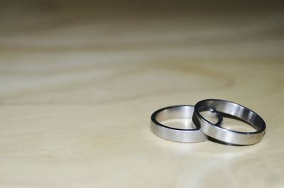 Close-up of wedding rings on table