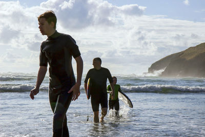 Rear view of man standing in sea