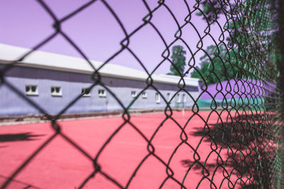 Close-up of soccer field seen through chainlink fence