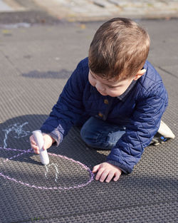 Kids drawing in chalk on the playground