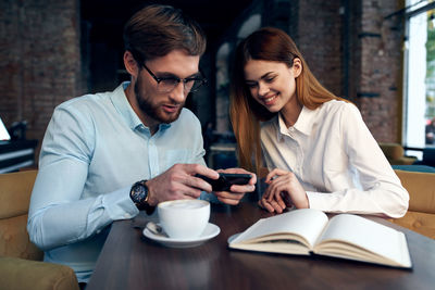 Young couple holding smart phone