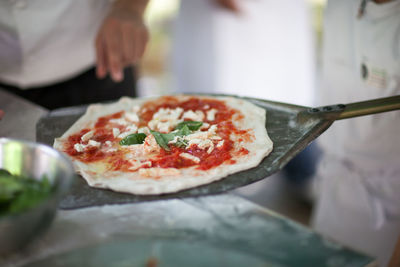 Close-up of pizza on pan in restaurant