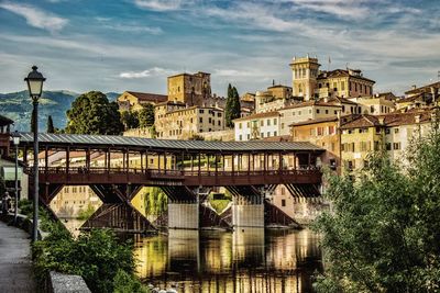 Arch bridge and buildings against sky in city