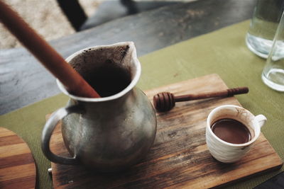 Close-up of coffee cup on wooden table