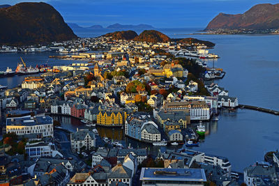 High angle view of townscape by sea against sky