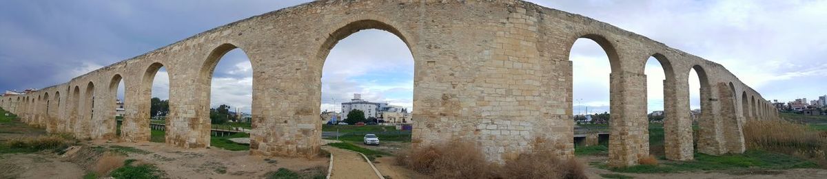 Low angle view of arch bridge against sky