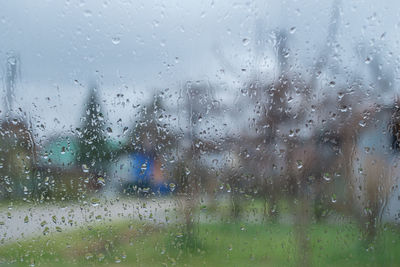 Full frame shot of wet glass window during rainy season