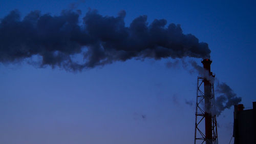 Low angle view of smoke stack against sky