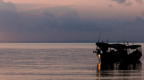 Koh rong island, cambodia at sunrise. strong vibrant colors, boats and ocean