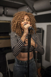 Singer performing in a recording studio