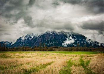 Scenic view of mountains against cloudy sky