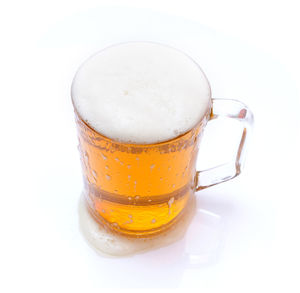 Close-up of beer glass against white background