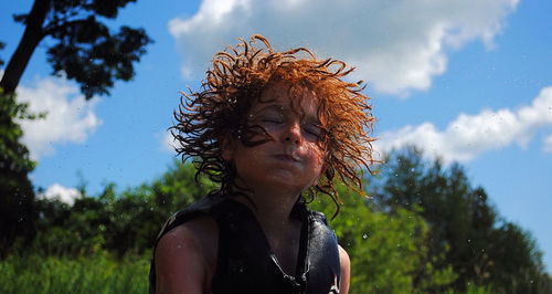 Close-up of a boy shaking hair