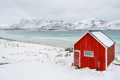 View of building on snow covered mountain against sky