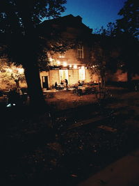 Illuminated building against sky at night