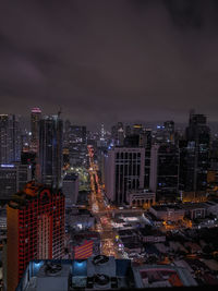 High angle view of illuminated buildings against sky at night