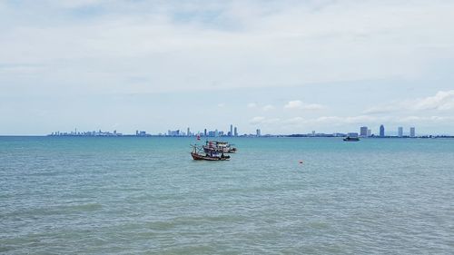 Sailboat sailing on sea against sky