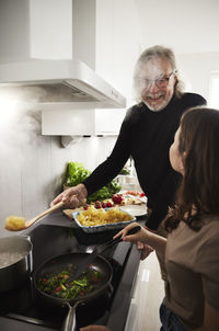 Family preparing meal in kitchen