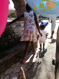 Rear view of people walking outdoors