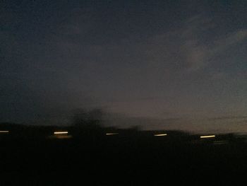 Illuminated city against sky at night