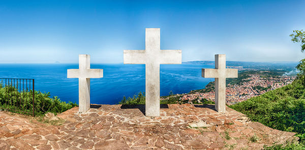 The iconic three crosses on the top of mount sant'elia overlooking the town of palmi, italy