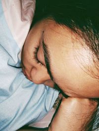 High angle view of man relaxing on bed